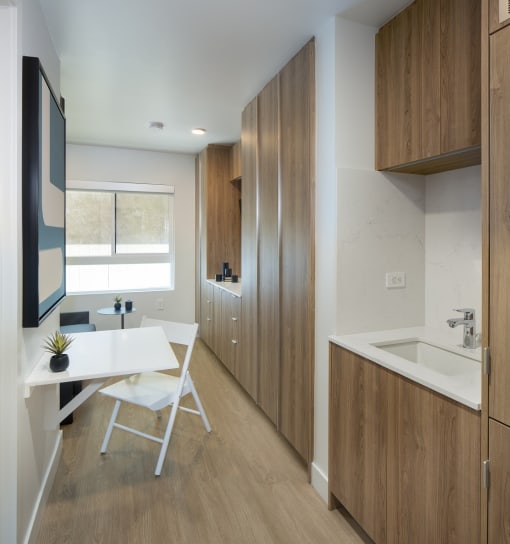 a home office with a desk and a sink