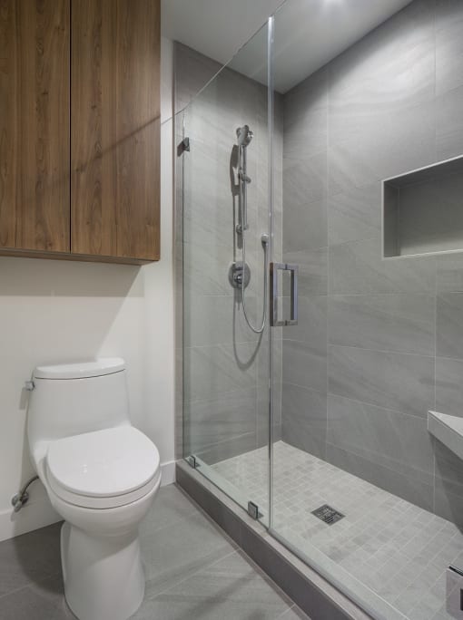 a bathroom with a toilet and a glass shower