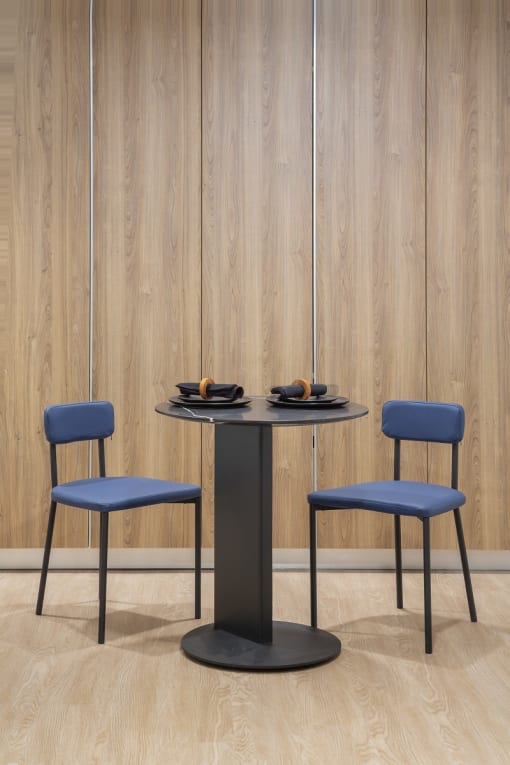 a black table with two blue chairs around it