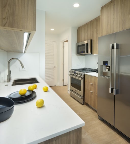 a kitchen with stainless steel appliances and a counter with lemons