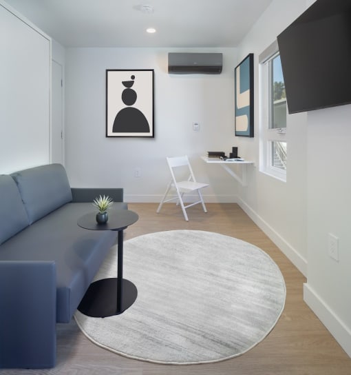 a living room with a blue couch and a table