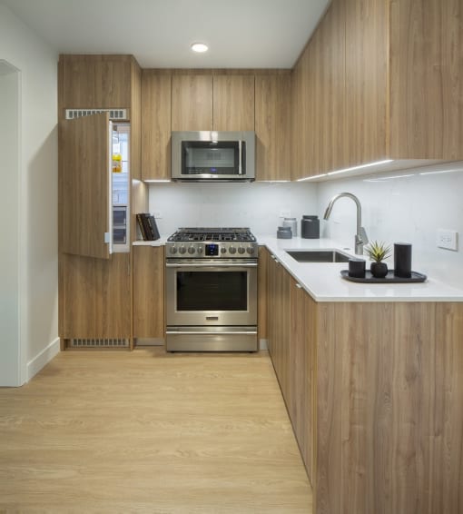 a kitchen with a stove and a sink and a microwave