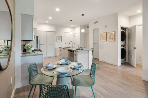 an open kitchen and dining room with a table and chairs