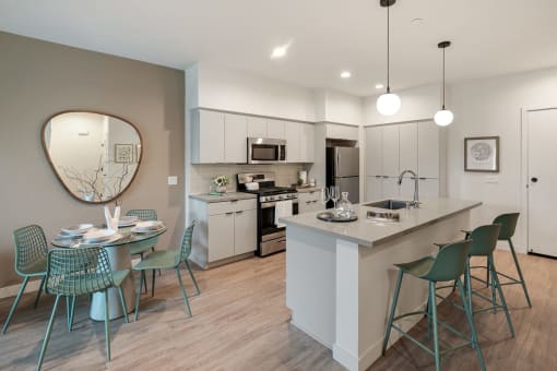 an open kitchen and dining area with a table and chairs