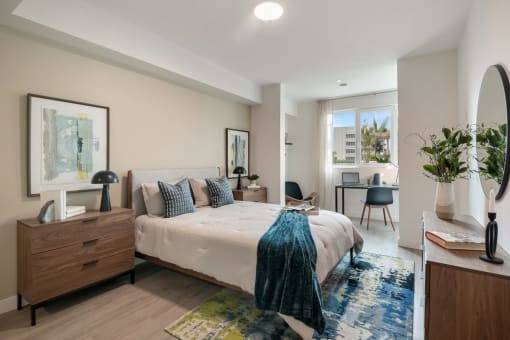 a bedroom with a bed and a desk with a chair