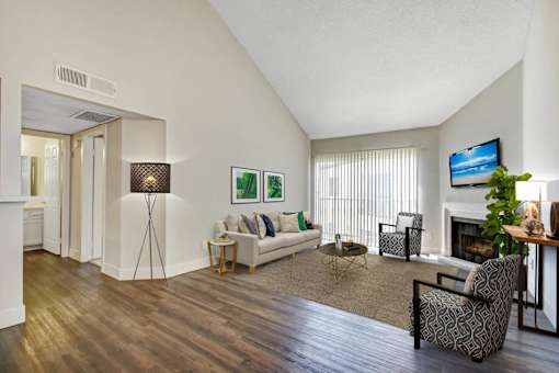A living room with a fireplace and a television.