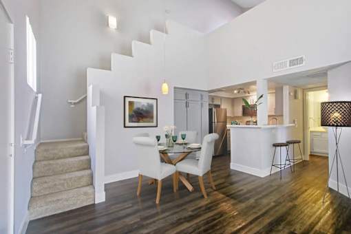 A dining room with a white table and chairs.