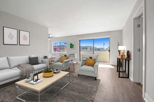 A living room with a grey sofa, a yellow coffee table, and a grey armchair.