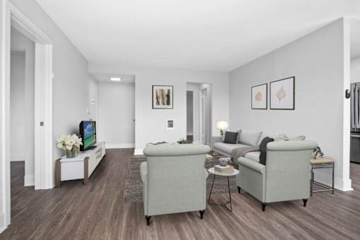 A living room with a grey couch and a white coffee table.