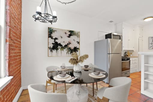 a dining room with a table and chairs and a refrigerator