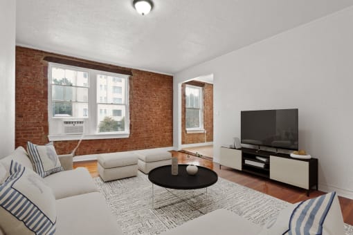 a living room with a couch and a table and a television