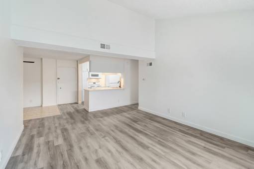 A room with a white wall and a grey floor.