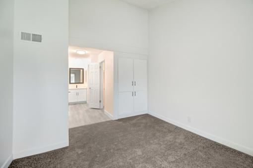 A room with white walls and a carpeted floor.
