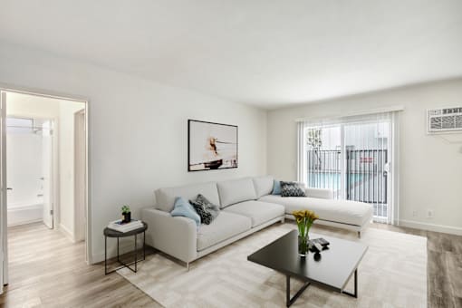 A living room with a white couch and a coffee table.