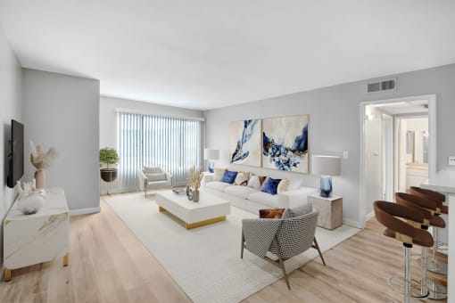 a living room with a white couch and a white rug