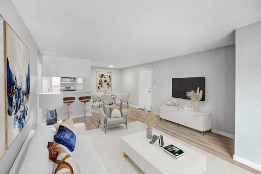 a living room with a white couch and a tv