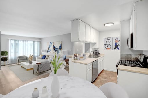 a kitchen and living room with a table and a sink