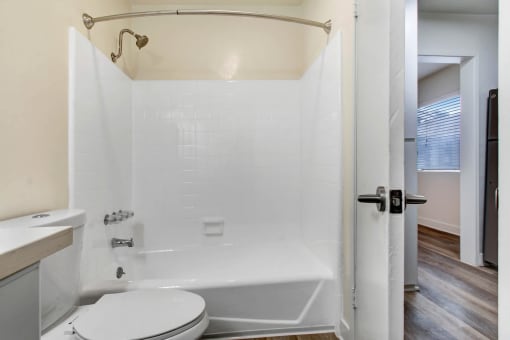 a bathroom with a tub and a toilet