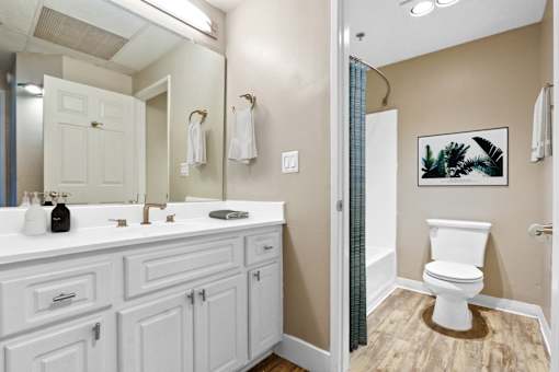 A bathroom with a white toilet and a white sink.