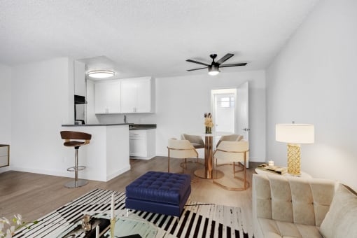 an open living room and kitchen with a table and chairs