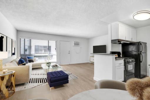 the living room of an apartment with a kitchen and a living room