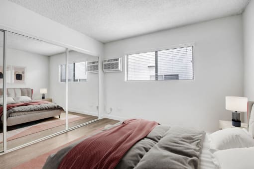 a bedroom with a large bed and a mirror