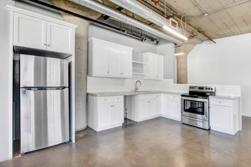a kitchen with white cabinets and stainless steel appliances
