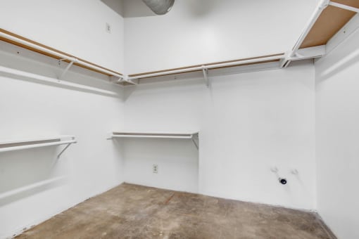 an empty room with white walls and concrete floors