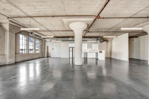 an empty warehouse space with a column in the middle of the floor