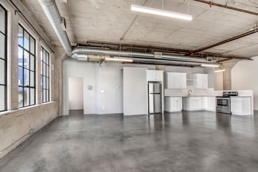 an empty room with white walls and concrete floors