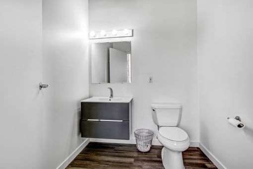 a bathroom with a toilet sink and mirror