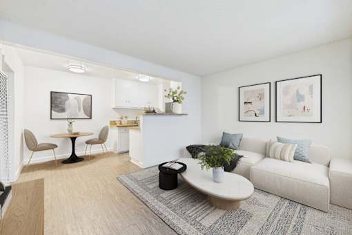 A living room with a white couch, a round table, and a rug.