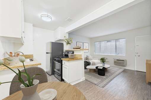 A modern kitchen with a dining table and chairs.
