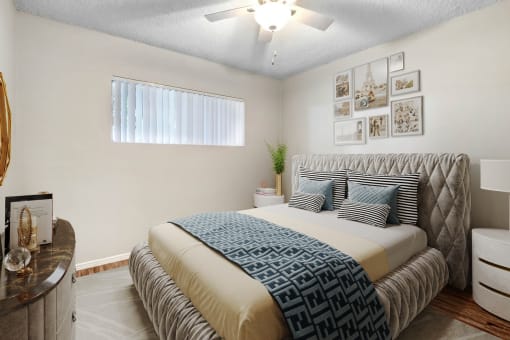 a bedroom with a bed and a ceiling fan