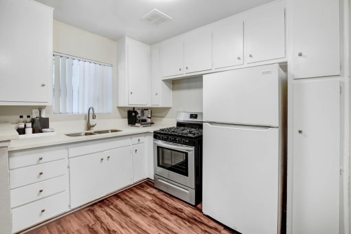 the preserve at ballantyne commons apartment kitchen with white cabinets and stainless steel appliances