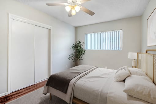 a bedroom with a large bed and a ceiling fan