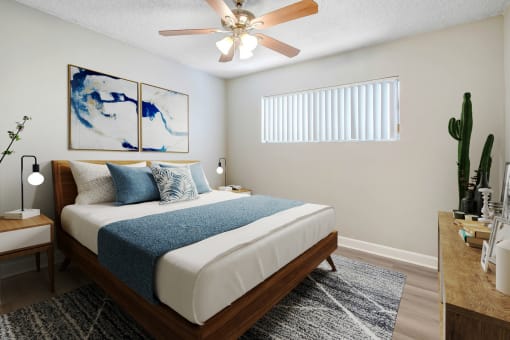 a bedroom with a white bed and a ceiling fan
