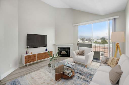 A living room with a fireplace and a flat screen TV.
