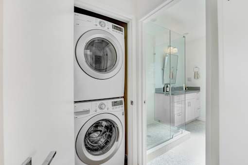 A white washing machine and dryer in a laundry room.