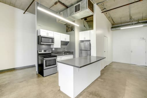 a kitchen with an island and stainless steel appliances