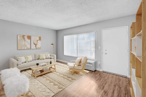 the living room of an apartment with a couch and a chair