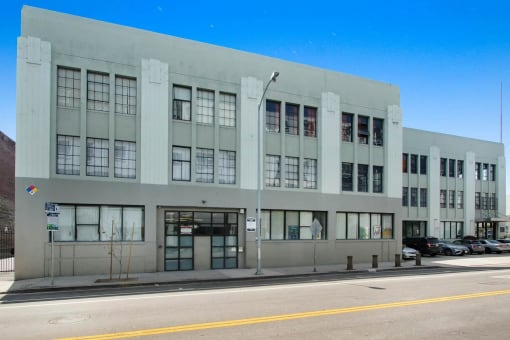 a large white building with many windows on a street