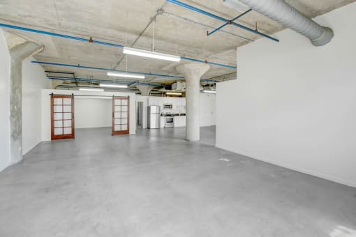 the interior of a large parking garage with white walls and concrete floors