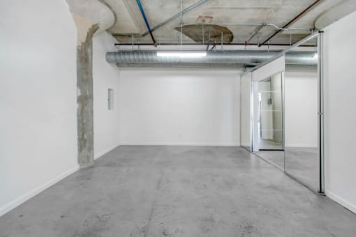 an empty room with a glass door and white walls