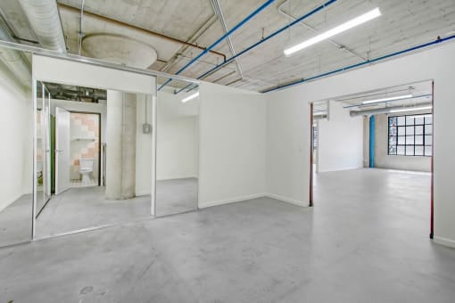 the interior of an empty room with white walls and glass doors