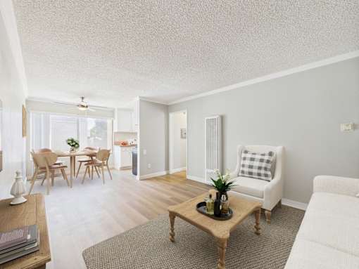 A living room with a white couch and a coffee table.