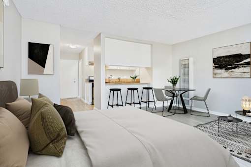 A modern living room with a grey sofa and a black and white abstract painting on the wall.