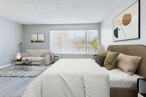A bedroom with a large bed and a couch.