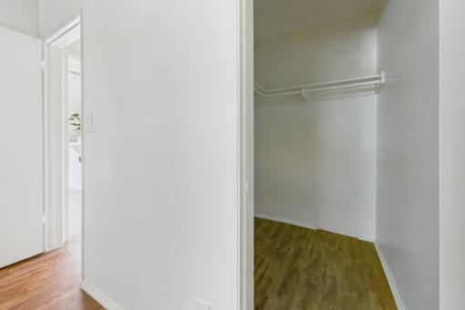 A room with a white wall and a wooden floor.
