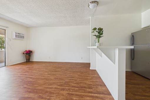 A room with wooden floors and white walls.